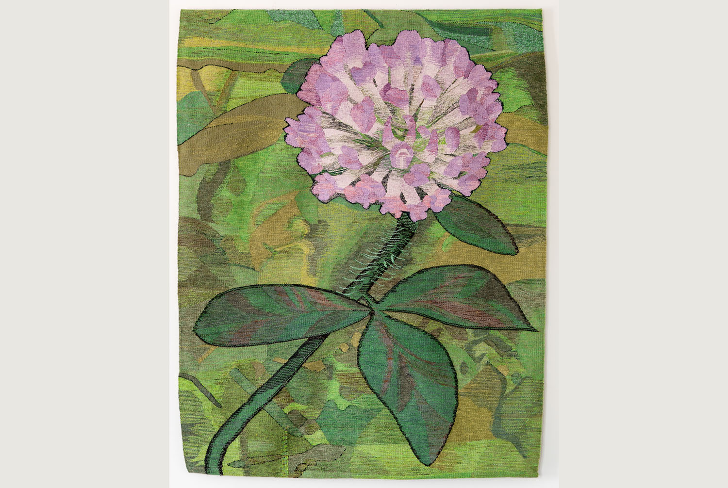 woven rug with an image of a purple flower